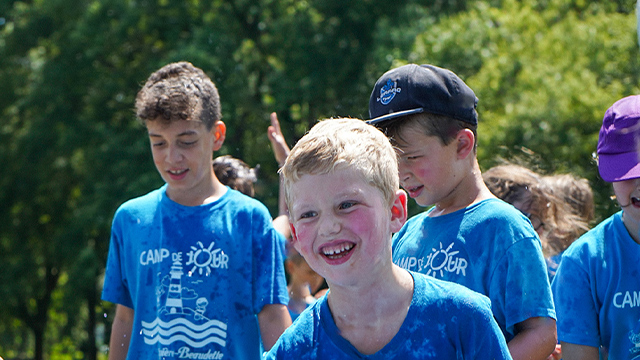 Young boys walk outside on a beautiful summer's day as part of a day camp group activity offered at Fort Chambly National Historic Site.