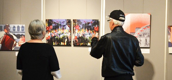 An aged couple admiring art paintings
