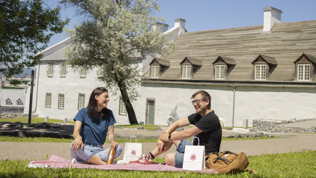 Two visitors with a picnic sitting in front of the Dauphine redoubt.