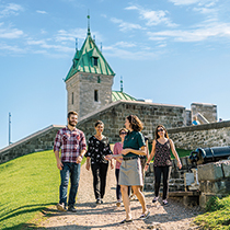 Visitors following a guided tour of the Fortifications of Québec in the company of a Parks Canada guide.