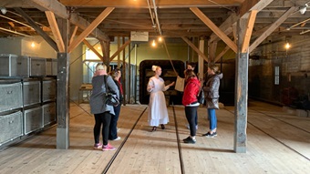  Visitors participate in the medical inspection in the disinfection building accompanied by an employee dressed as a nurse.