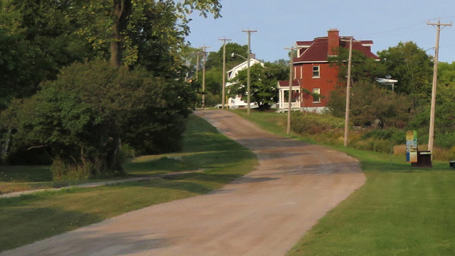  A view of the Grosse Île road with two houses in the distance.