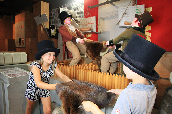 Two children fight over a beaver fur for fun