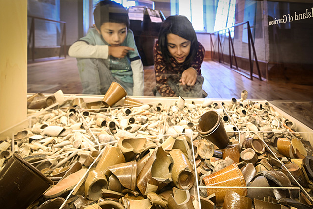 Two children look at artifacts from Fort Lennox National Historic Site.