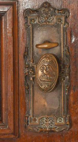 Knob on the door leading to the carriage entrance, at ground floor.