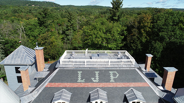 A view from the roof of the Manoir Papineau National Historic Site, showing the three letters “LJP.”