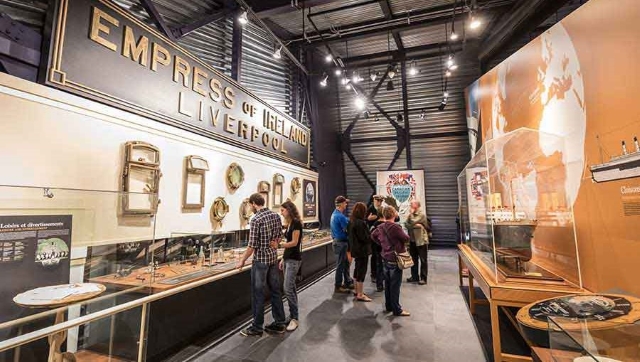 Group of visitors in the museum of the Empress of Ireland /  