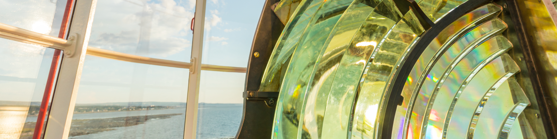 Lens at the top of the lighthouse with a view of the river.