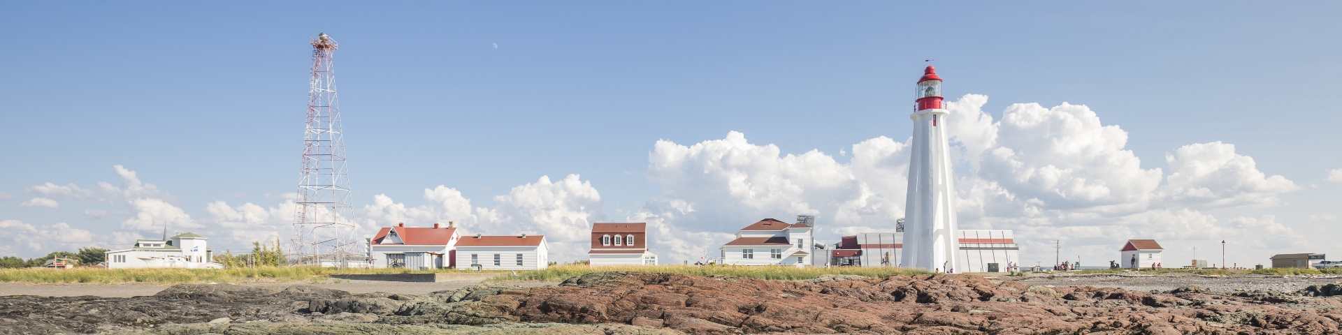 View of buildings and lighthouse from the sea. 