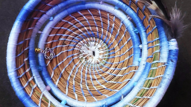 A basket, similar to a coin tray, made from white pine needles.