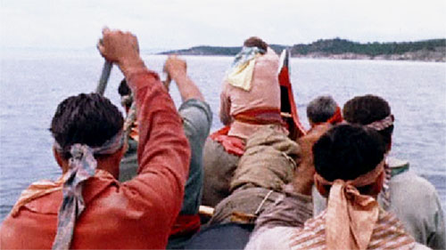 group of voyageurs paddling in a rabaska