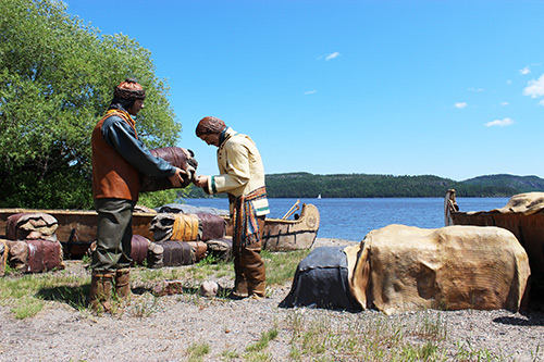 Photo of two trappers representations dealing furs