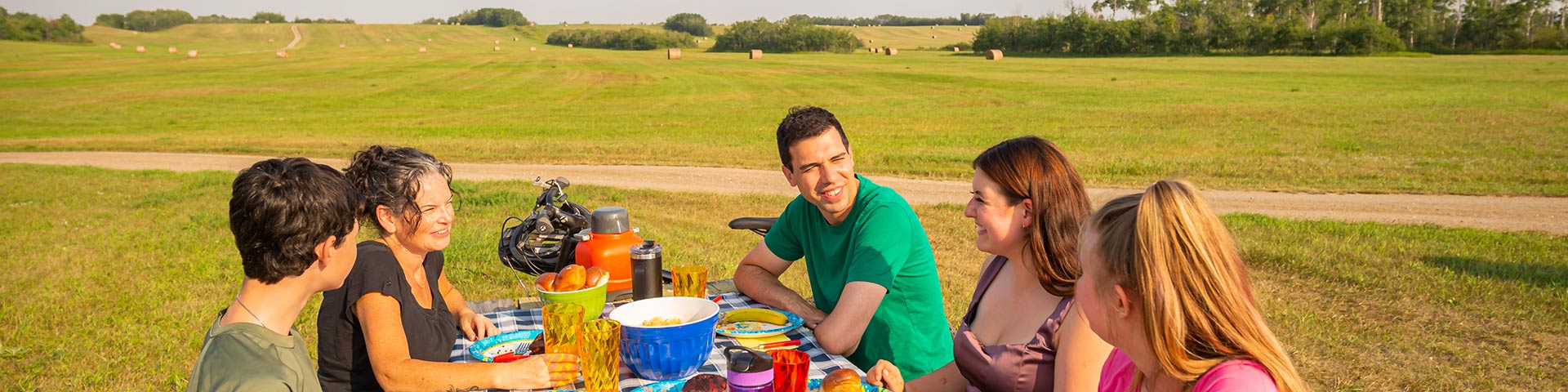 Visitors smiling have a picnic at the East Village