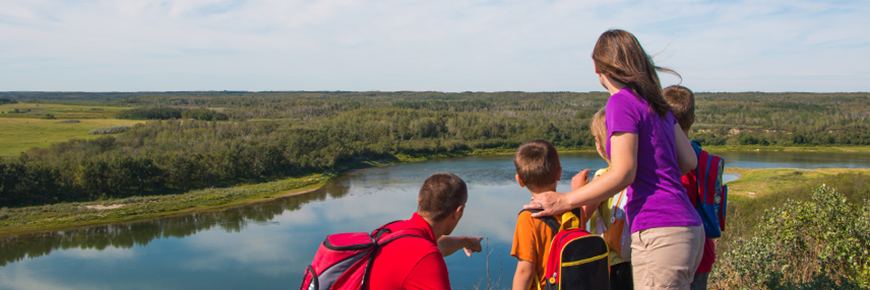 Une famille contemplant le panorama au bord d’une rivière 