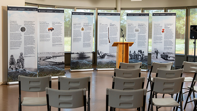 Presentation space at Fort Battleford National Historic Site with podium, seating, and displays.