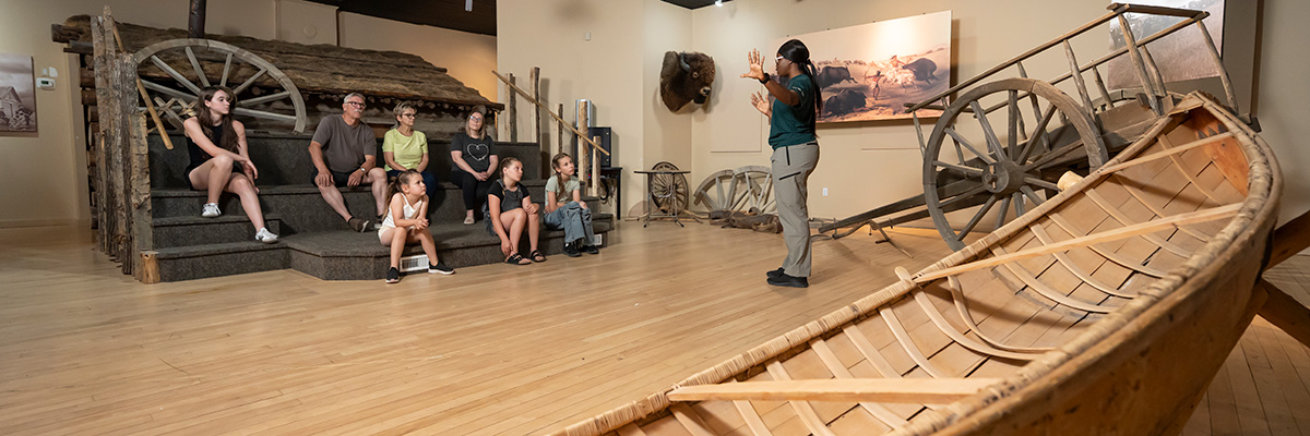 A Parks Canada heritage presenter speaks to a group of visitors inside Barracks #5. 