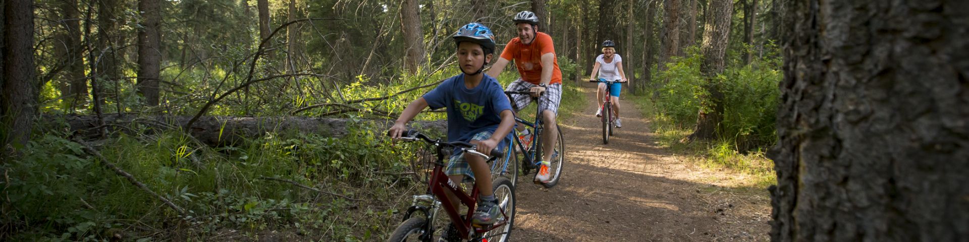 Famille à vélo sur un des sentiers de l'arrière-pays, dans les collines Cypress, au lieu historique national du Fort-Walsh.