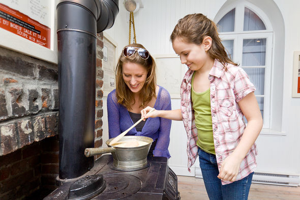 Woman and child sniffing soup, Fisgard Lighthouse National Historic Site