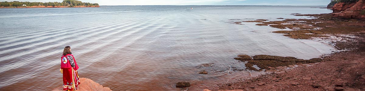 A Mi'kmaq woman on the shore overlooking the mouth of the Hillsborough River.