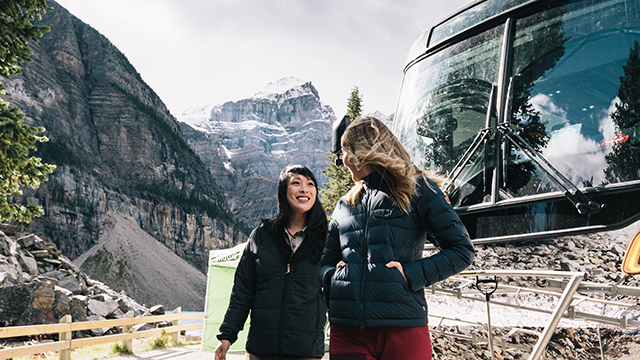 two visitors getting off the bus at lake louise