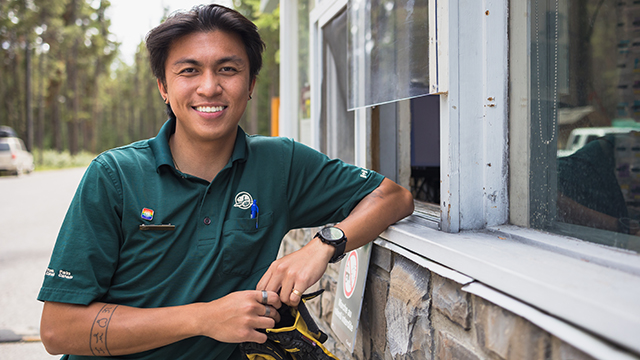 parks canada staff member smiling at window kiosk