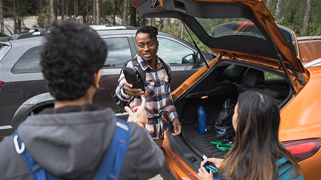 visitor opening car trunk passing bears pray to friend 