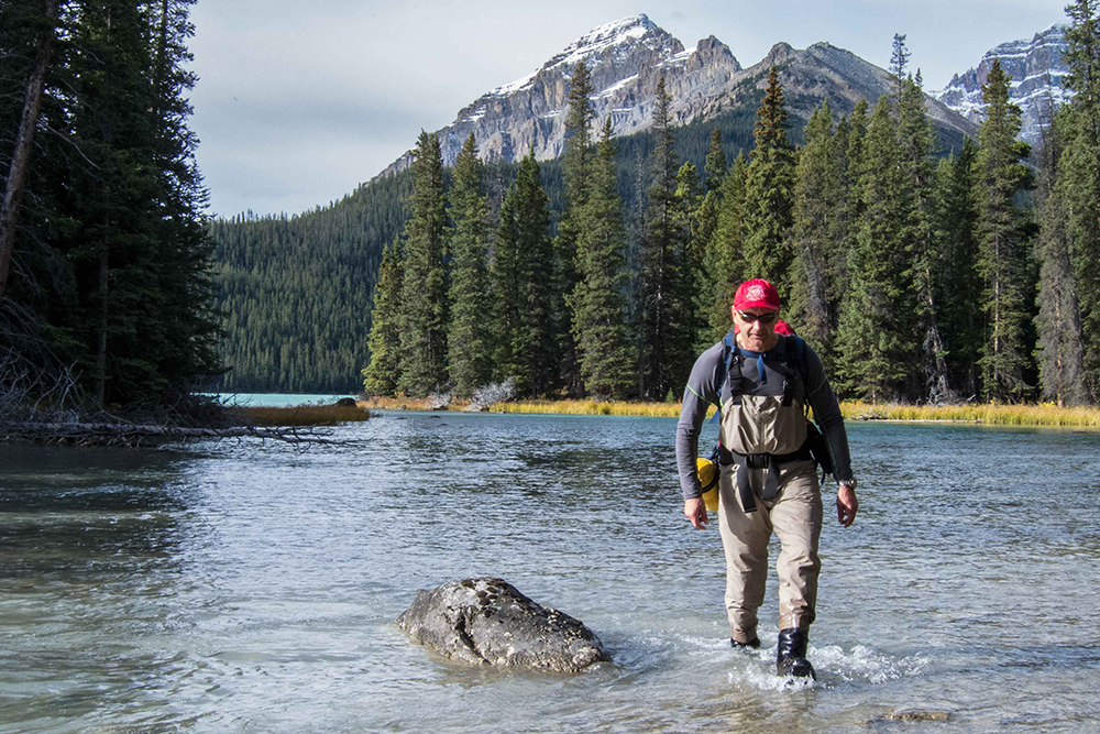 parks canada staff walking through creek