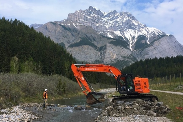 A small excavator is used on the side of Cascade Creek.