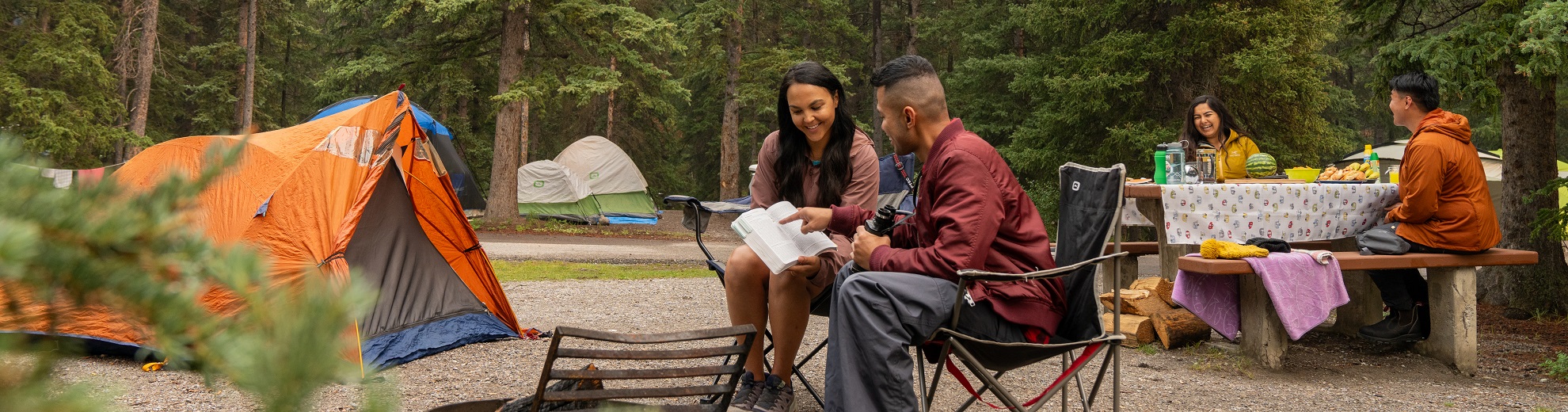 two friends enjoying time at campground within Banff National Park. 