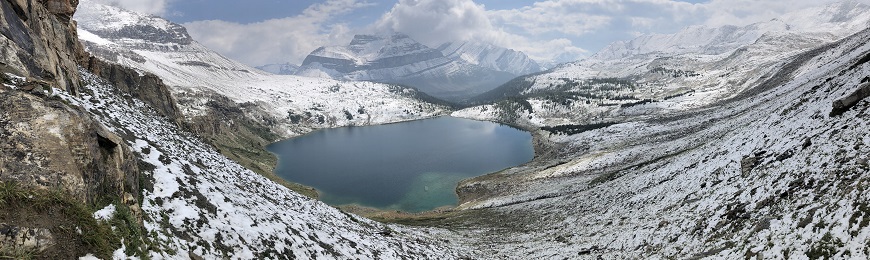 Lake surrounded by snow covered mountains
