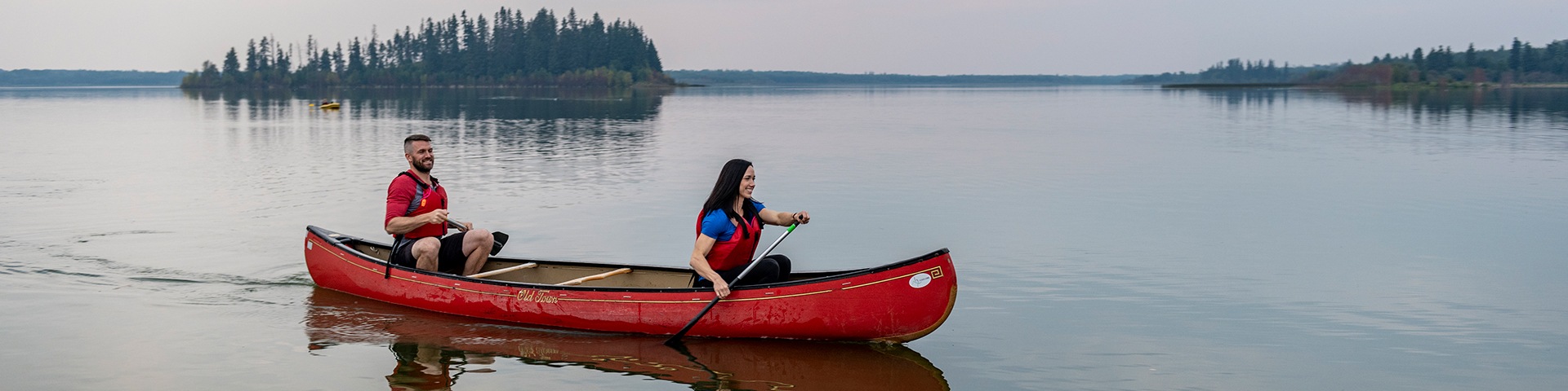 Canoers paddle on Astotin Lake, Elk Island National Park. Elk Island National Park