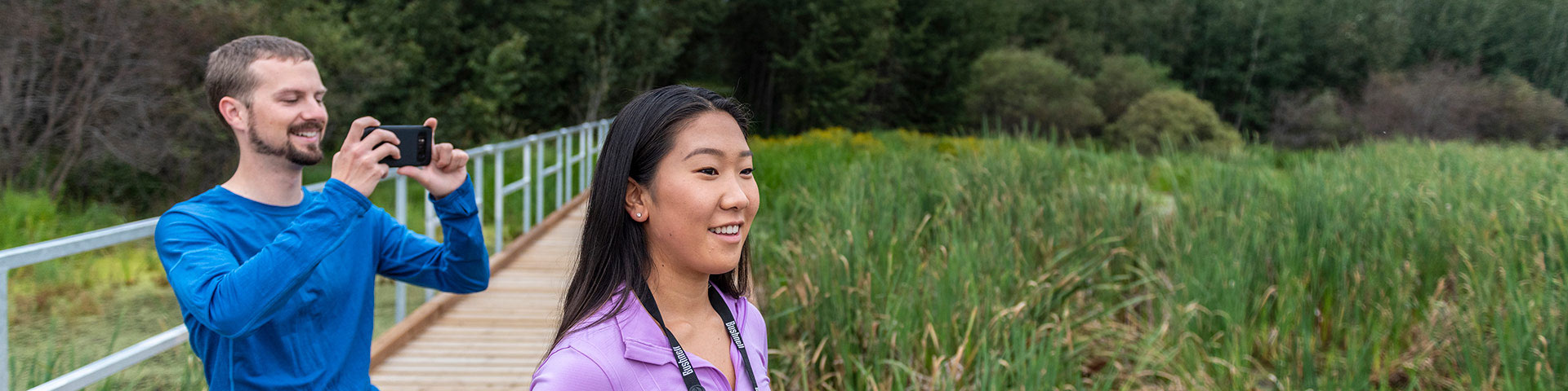 A couple captures photographs from the Living Waters Boardwalk... Elk Island National Park