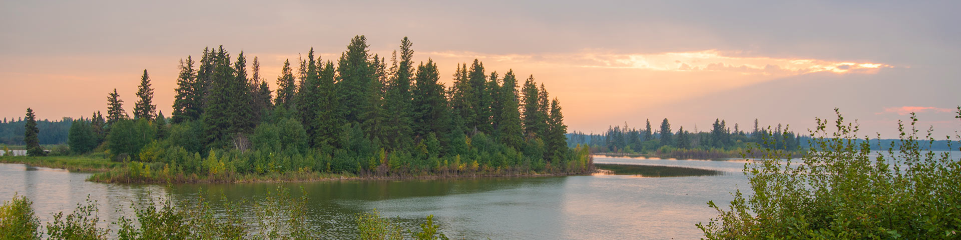 The islands of Astotin Lake at sunset.