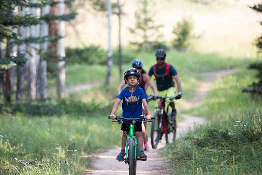 Family biking on a gravel path.