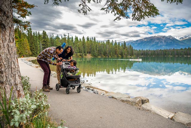 A family pushes a stroller on the Lake Annette trail.