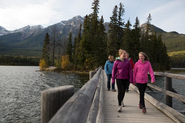 A family walks on the bridge at Pyramid Island.