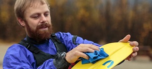 Close-up of a bearded adult cleaning a paddle.