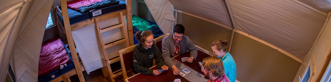 Group playing cards inside an oTENTik.