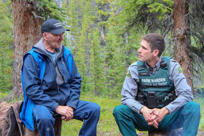 An Indigenous Guardian and Park Warden exchange stories