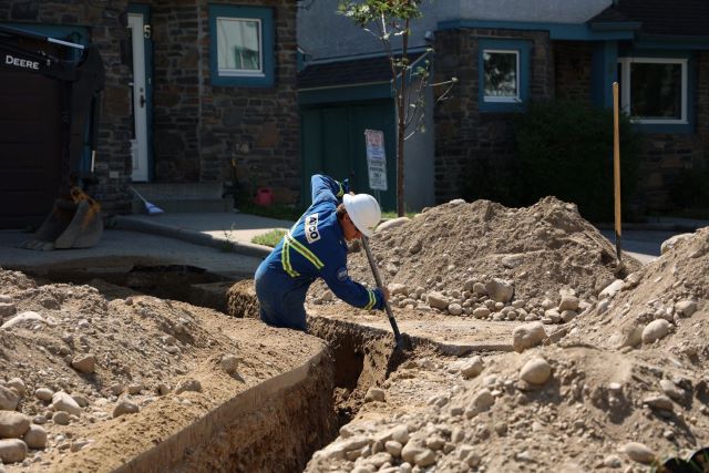 ATCO crew member working on critical infrastructure in residental area