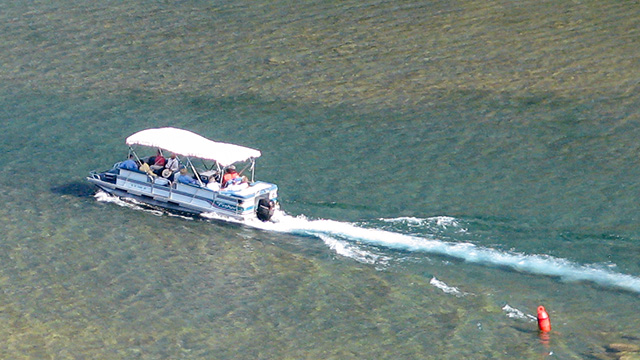 powerboat travels through shallow waters