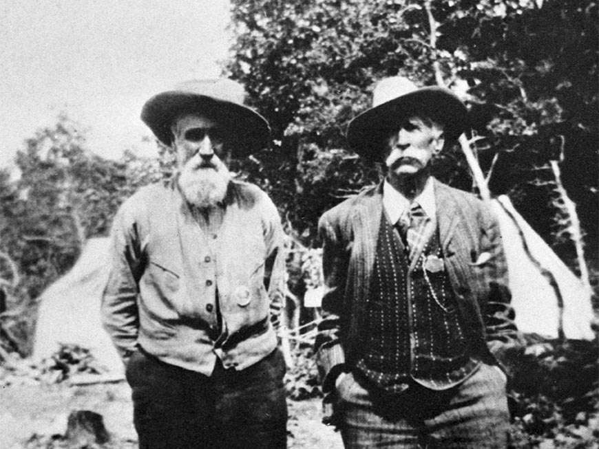 A portrait of Waterton Lakes Forest Park Reserve Ranger John George 'Kootenai' Brown and U.S. Ranger Albert 'Death-on-the-Trail' Reynolds