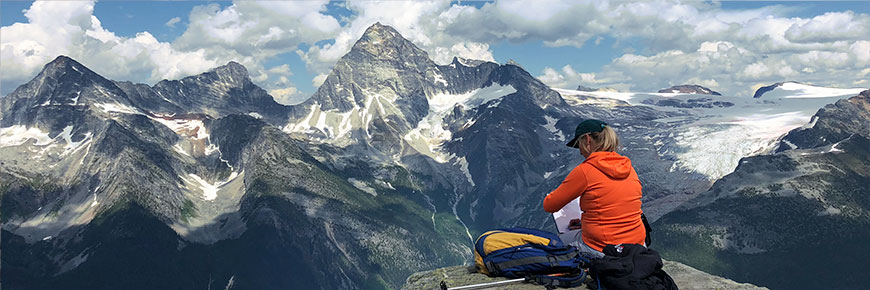 An artist painting a picture on Abbott Ridge in Glacier National Park