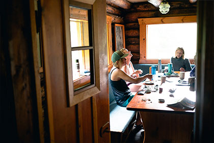Artists inside the A.O. Wheeler Hut in Glacier National Park