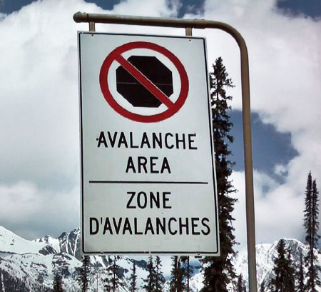 Road sign in Rogers Pass indicating no stopping due to avalanche danger