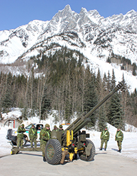 C-3 Howitzer with Canadian Armed Forces behind.