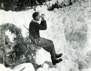PSA.58 P. Schaerer observing the path incline of an avalanche. Apr. 1957. © Revelstoke Museum and Archives Peter Schaerer using inclinometer to measure the angle of a slope