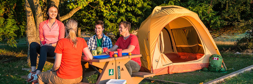 Group of friends relax by their tent