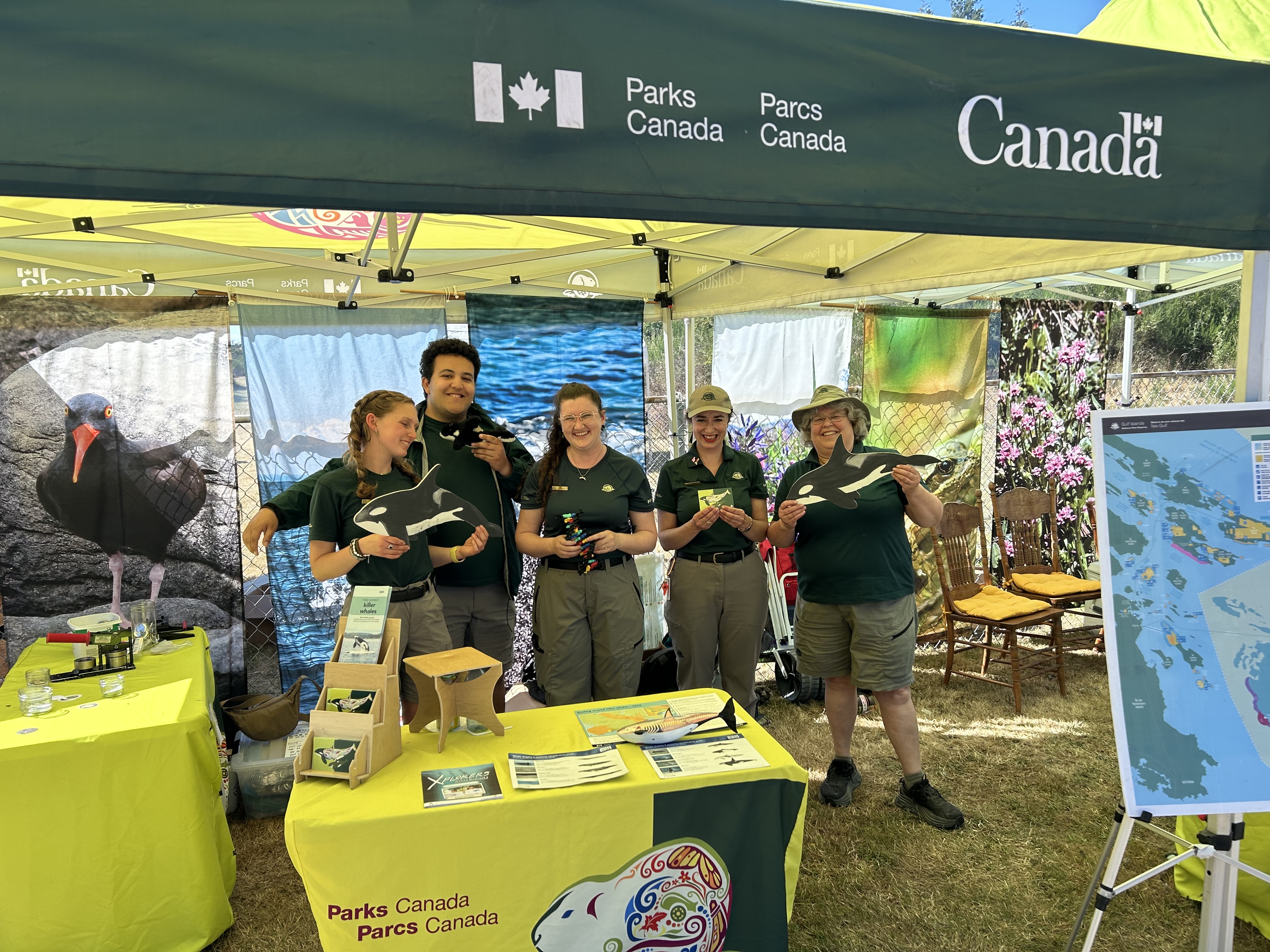 Parks  Canada employee with young child at Saturna Lamb event.