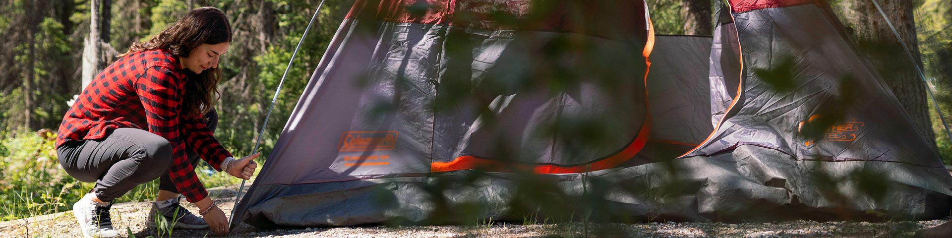 a camper setting up their tent